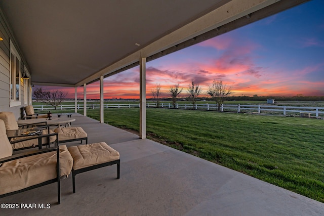 view of patio featuring fence and a rural view