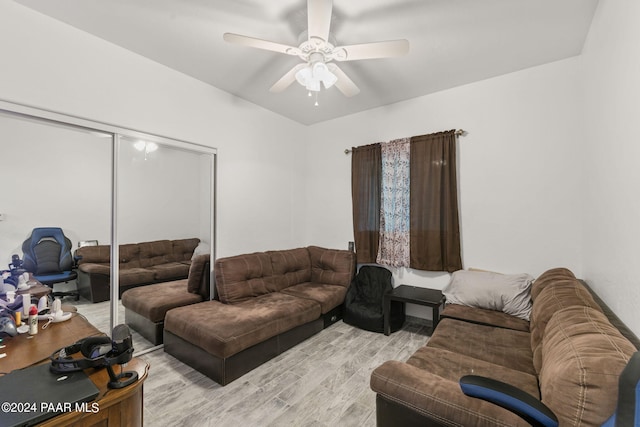 living room featuring ceiling fan and light hardwood / wood-style flooring