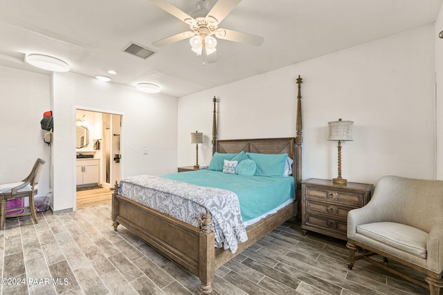 bedroom with hardwood / wood-style flooring, ceiling fan, and ensuite bath