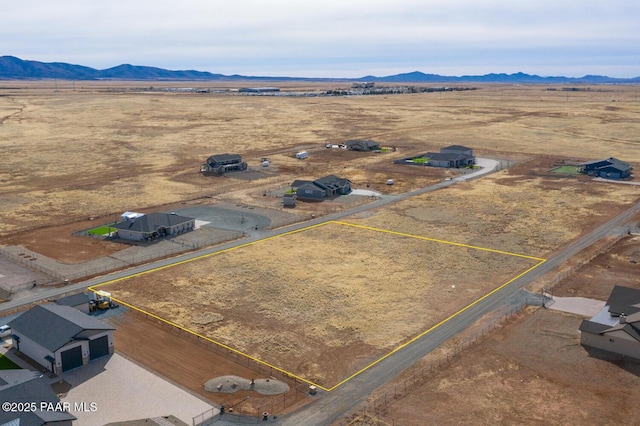 aerial view featuring view of desert, a mountain view, and a rural view