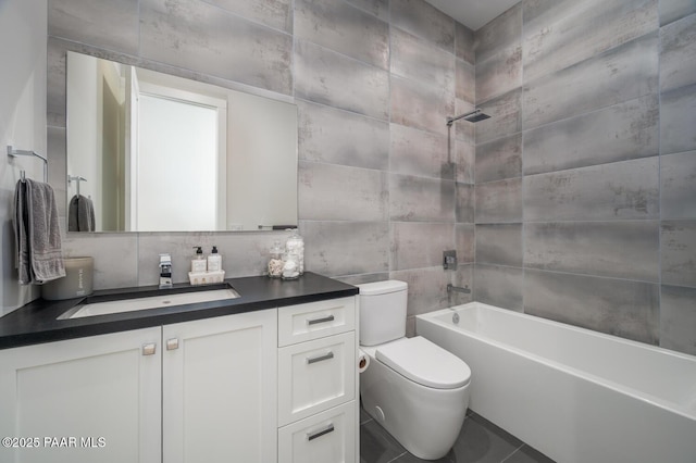 bathroom featuring decorative backsplash, toilet, vanity, tile walls, and shower / bathing tub combination