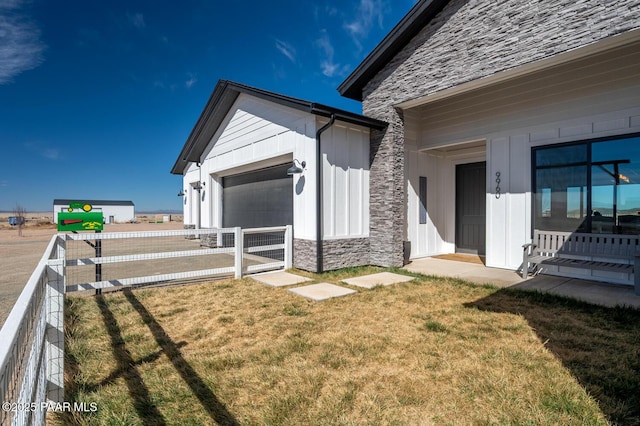 view of yard with an attached garage and fence