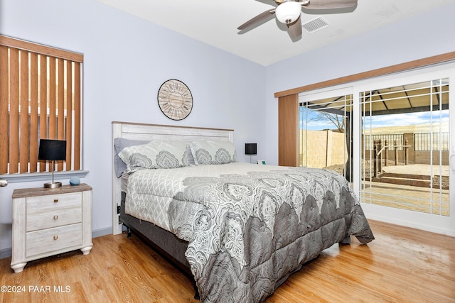 bedroom featuring visible vents, ceiling fan, baseboards, wood finished floors, and access to outside