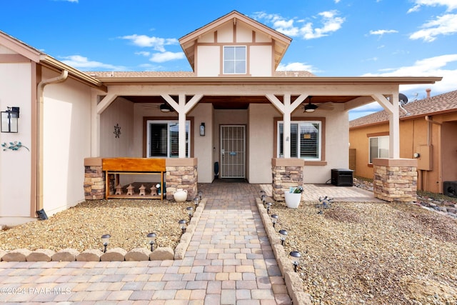 view of front of home featuring stone siding and stucco siding