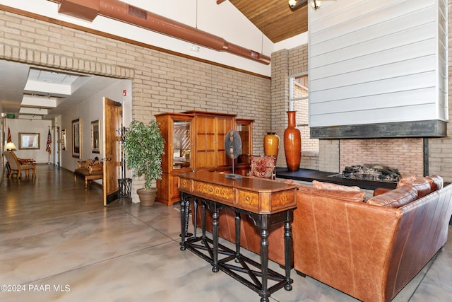 living room with brick wall, finished concrete flooring, and a towering ceiling