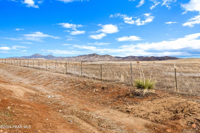 view of yard with a mountain view, a rural view, and fence