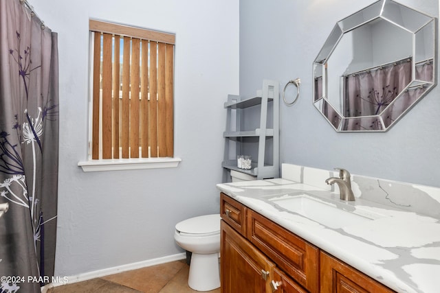 bathroom with tile patterned floors, toilet, a shower with shower curtain, baseboards, and vanity