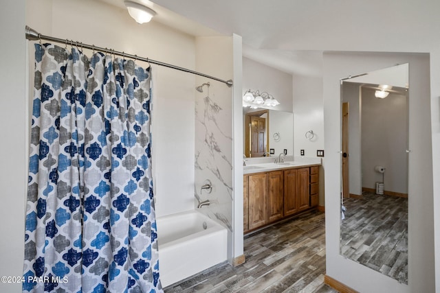 bathroom with hardwood / wood-style flooring, shower / bath combo, and vanity