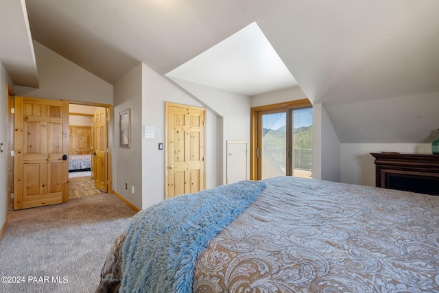 carpeted bedroom featuring access to exterior and vaulted ceiling