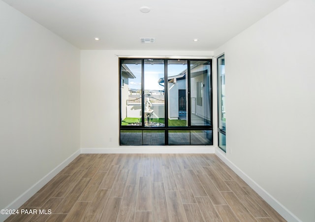 unfurnished room with light hardwood / wood-style flooring