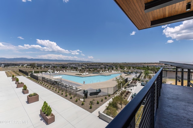 view of swimming pool with a mountain view