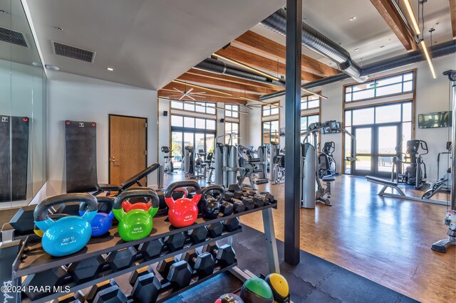 workout area with a high ceiling and dark hardwood / wood-style floors