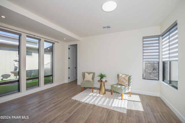 sitting room with hardwood / wood-style flooring