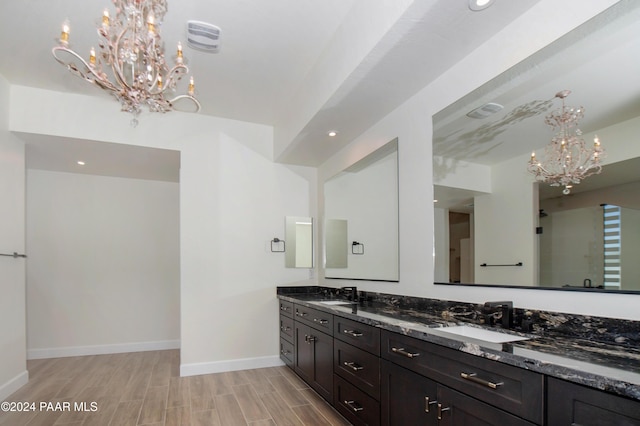 bathroom featuring vanity, hardwood / wood-style flooring, and a notable chandelier