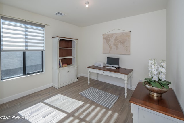 office space featuring plenty of natural light and light hardwood / wood-style floors