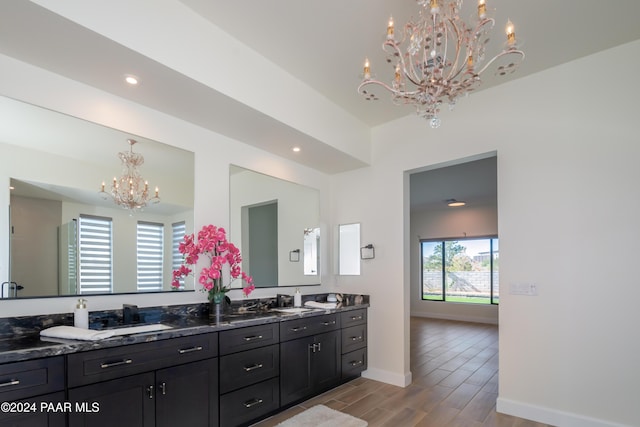 bathroom featuring vanity, wood-type flooring, and an inviting chandelier