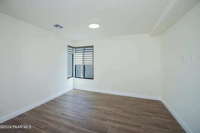 unfurnished room with dark hardwood / wood-style flooring