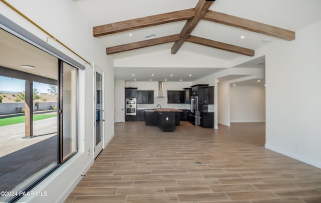 living room with hardwood / wood-style floors and lofted ceiling with beams