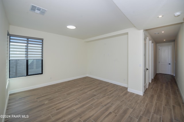 spare room with dark hardwood / wood-style flooring