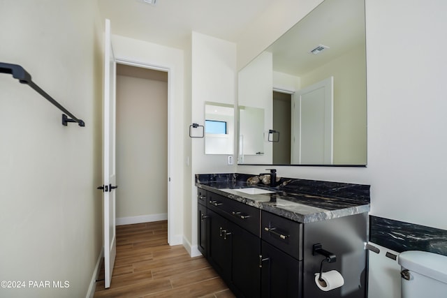 bathroom featuring hardwood / wood-style flooring, vanity, and toilet