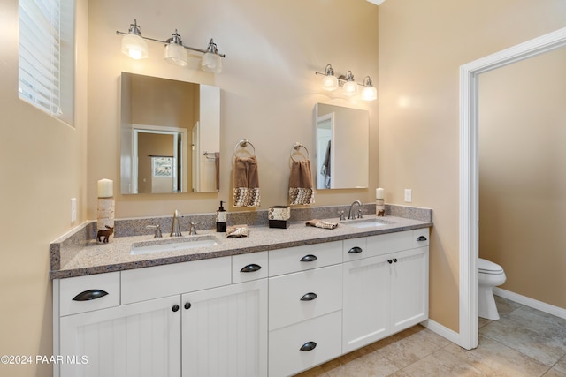 bathroom with tile patterned floors, vanity, and toilet