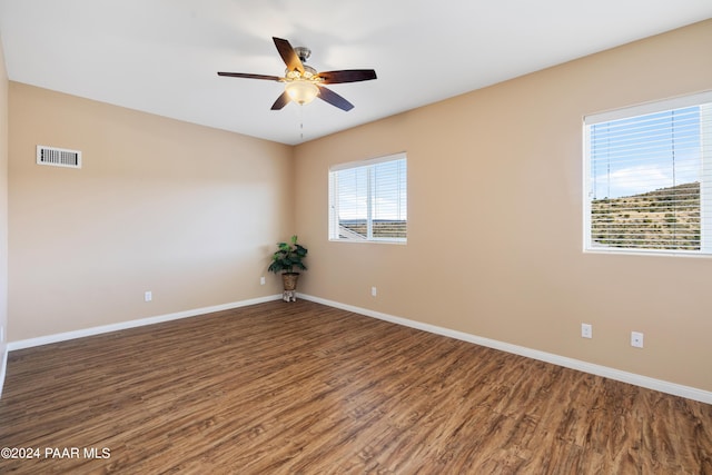 unfurnished room with ceiling fan and dark hardwood / wood-style flooring