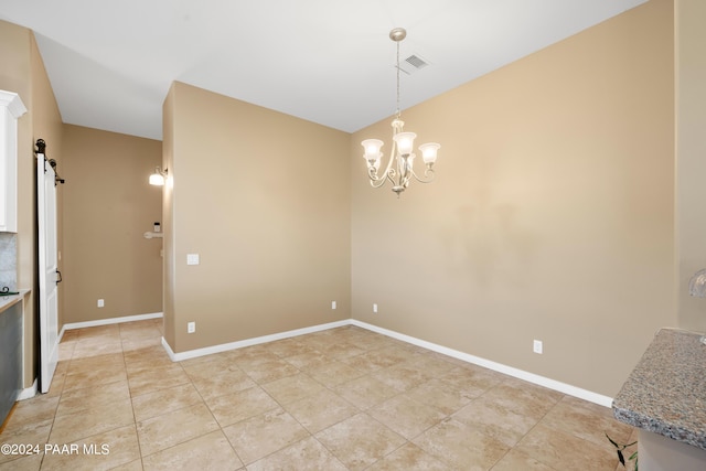 unfurnished dining area with a notable chandelier, a barn door, and light tile patterned floors