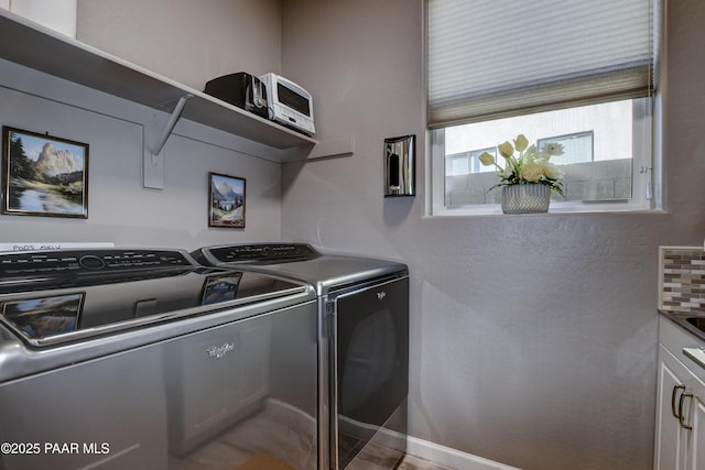 laundry area with cabinets and washing machine and dryer