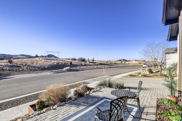 view of patio / terrace featuring a mountain view