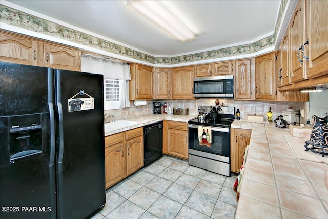 435 Jasmine Ln, Prescott, AZ 86301 - kitchen with light tile patterned floors, black appliances, tile countertops, and decorative backsplash