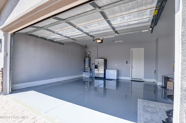 garage with stainless steel fridge, gas water heater, and a garage door opener