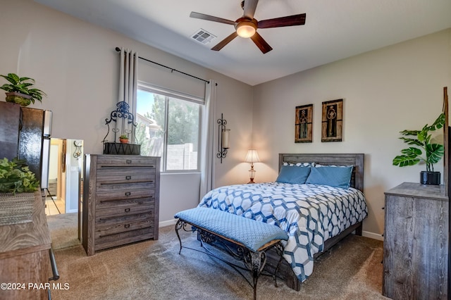 carpeted bedroom with ceiling fan and stainless steel refrigerator