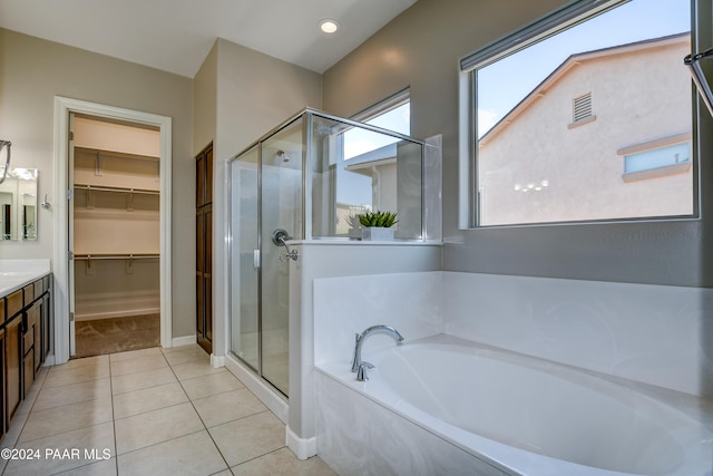 bathroom featuring tile patterned floors, vanity, and shower with separate bathtub