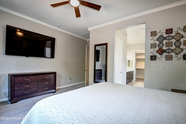 carpeted bedroom with a walk in closet, ceiling fan, ensuite bathroom, and ornamental molding