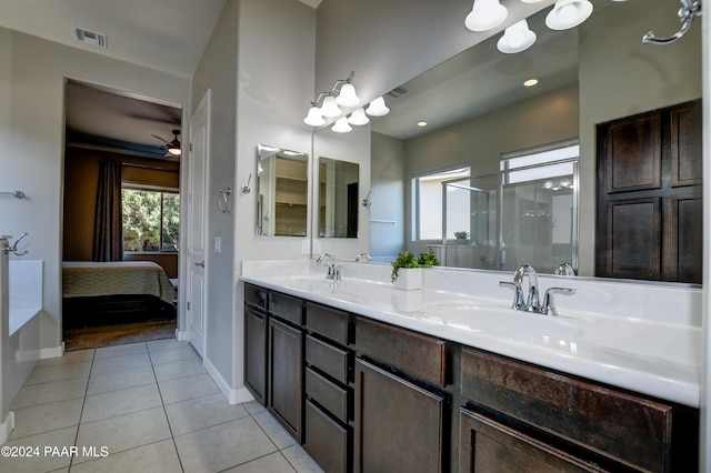 bathroom featuring tile patterned floors, vanity, ceiling fan, and a shower with door