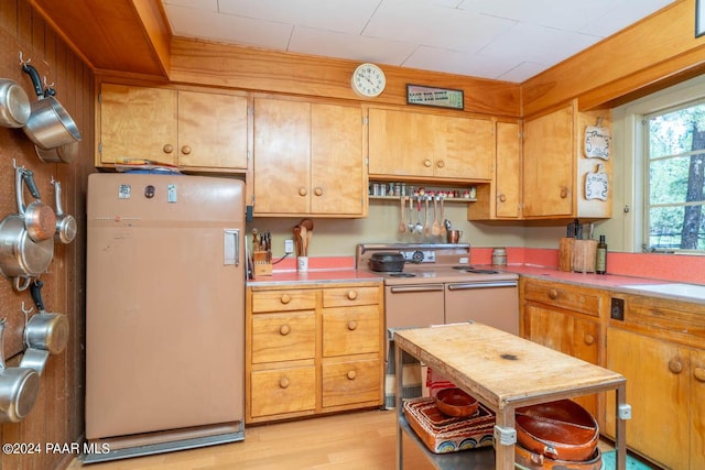 581 Cooper Ranch Rd, Williams, AZ 86046 - kitchen featuring brown cabinets, white appliances, light countertops, and light wood-style floors