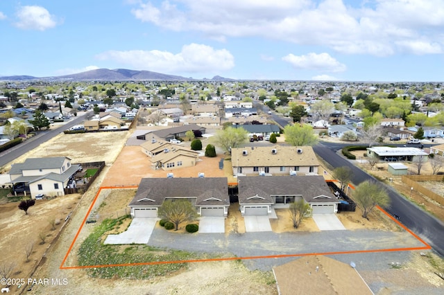 drone / aerial view featuring a residential view and a mountain view