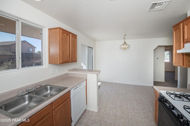 kitchen featuring a notable chandelier, range with gas cooktop, a sink, visible vents, and white dishwasher