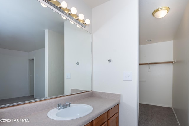 bathroom with baseboards and vanity