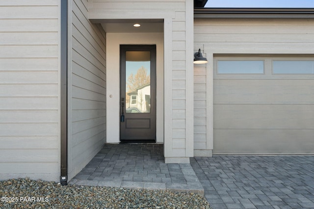 view of exterior entry with a garage