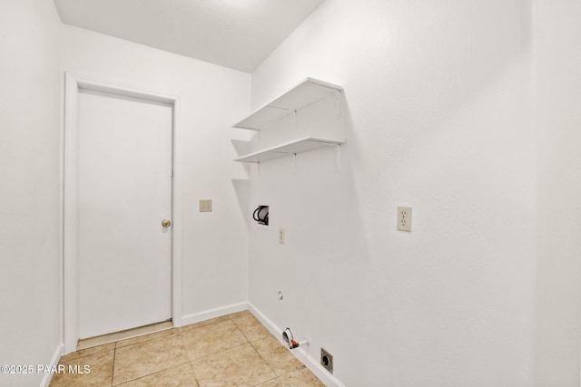 laundry area with baseboards, gas dryer hookup, laundry area, light tile patterned flooring, and hookup for an electric dryer