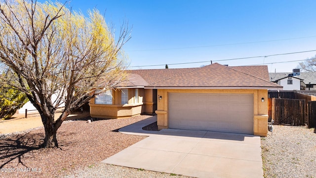 single story home with stucco siding, driveway, fence, an attached garage, and a shingled roof