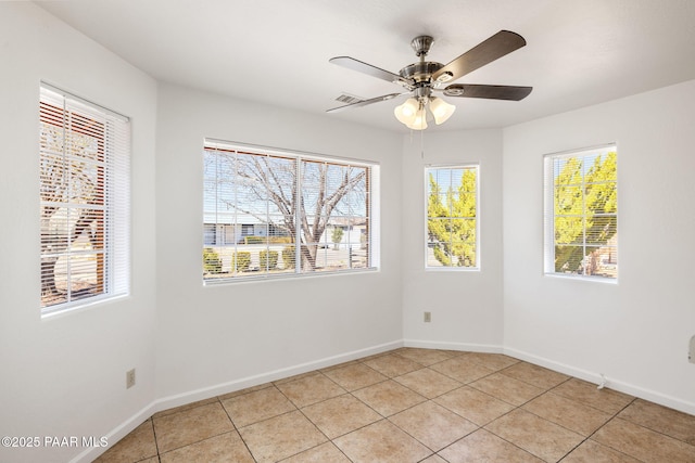 unfurnished room with light tile patterned floors, baseboards, and ceiling fan