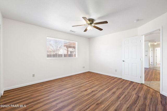 unfurnished bedroom featuring wood finished floors, visible vents, and baseboards