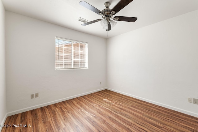 unfurnished room with visible vents, a ceiling fan, light wood-type flooring, and baseboards