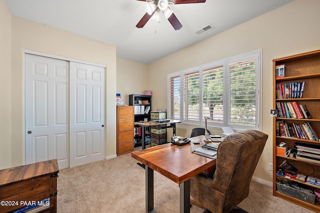 home office featuring ceiling fan and light carpet