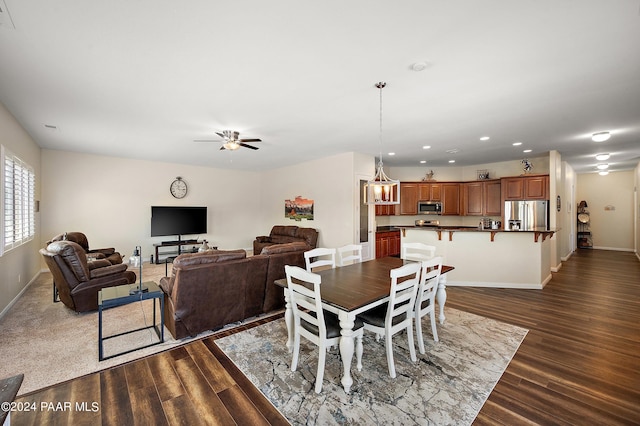 dining area featuring ceiling fan and dark wood-type flooring