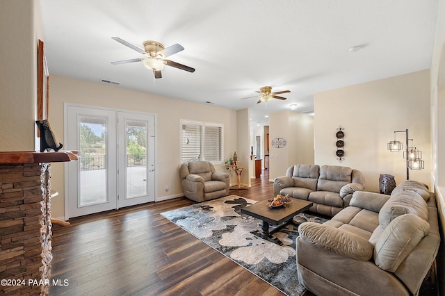 living room featuring ceiling fan and dark hardwood / wood-style floors