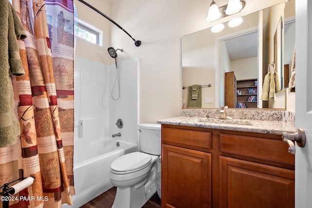 full bathroom with hardwood / wood-style floors, vanity, shower / tub combo, and toilet