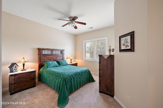 bedroom with light carpet and ceiling fan